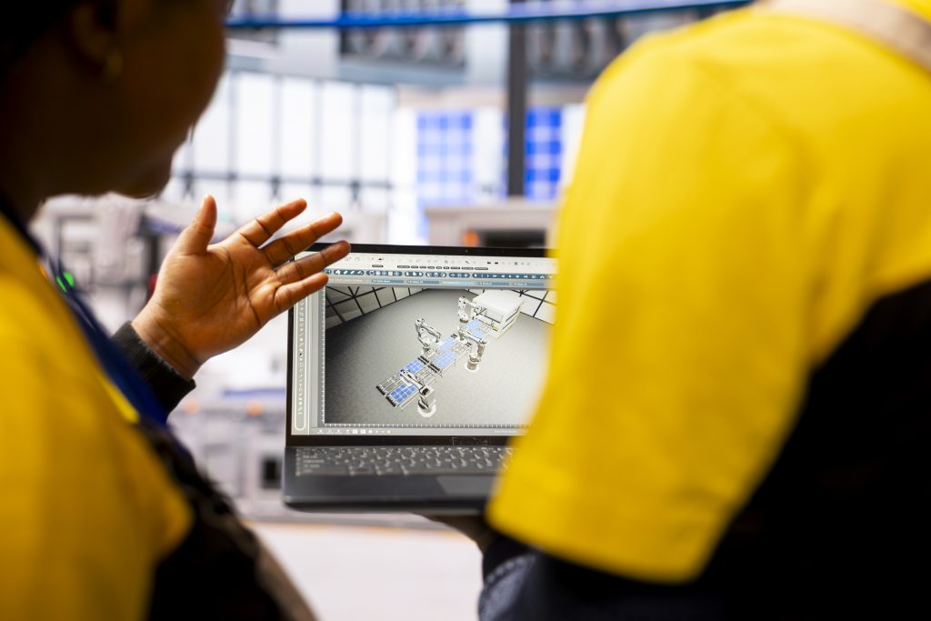 engineers optimizing manufacture robot arm conveyor belt